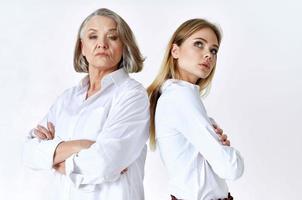 cute grandmother and granddaughter studio posing fun light background photo