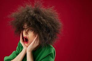 Positive young woman Afro hairstyle green dress emotions close-up color background unaltered photo