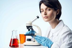female laboratory assistant chemical solution research work science photo