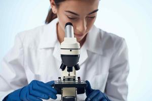 woman chemist laboratory microscope research biotechnology photo