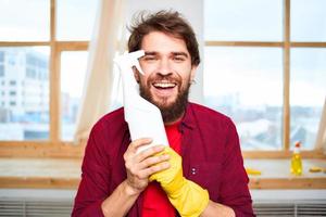 Cheerful man cleaning detergent homework hygiene interior photo