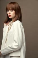 Pretty model in beige jacket gesticulate with hands photo