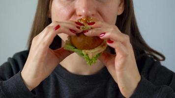 Woman eats juicy hamburger video