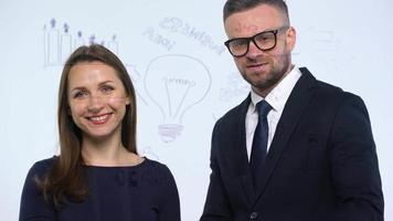 Man and woman rejoice in success and having fun in a modern glass office video