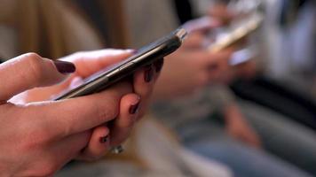 Group of people use mobile phones in a cafe instead of communicating with each other video