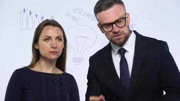 Man and woman rejoice in success and having fun in a modern glass office video