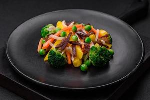 Delicious steamed vegetables broccoli, mushrooms, peas, carrots and onions photo
