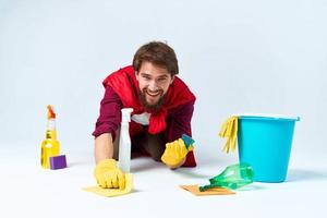 Man on the floor cleaning the house cleaning supplies Professional photo