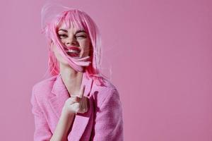 Beautiful fashionable girl in a pink blazer pink wig cropped view pink background unaltered photo