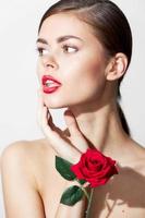 Girl with bare shoulders Model looks towards red lips body care photo