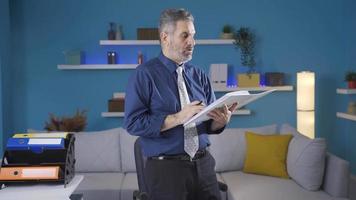 Mature businessman working from home doing his job happily and cheerfully. Happy and fun working mature businessman doing his job with pleasure and pleasure. video