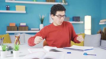 Happy and funny boy dancing at home, studying. Funny and energetic young boy dancing while studying, high spirits, full of humor. video