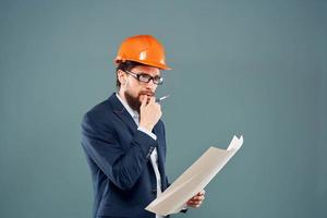 Male engineer with blueprints in the hands of an orange hard hat Industry professional photo