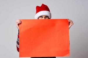 handsome man in a christmas hat with Red mockup poster isolated background photo