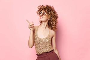 Beautiful woman curly hair Smile sunglasses fashion pink background Copy Space photo
