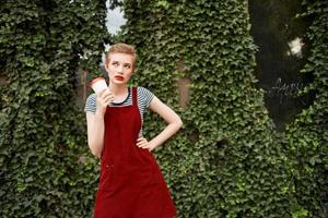 woman with short hair outdoors in summer cup of coffee photo