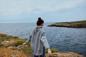 woman nature rocks coast landscape Ocean female relaxing photo