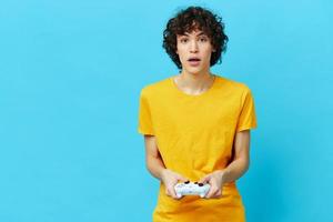 gamer plays with joystick in yellow t-shirts Lifestyle entertainment photo