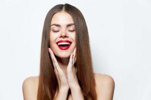 Sexy woman Laughs and touch his face with his hands red lips isolated background photo