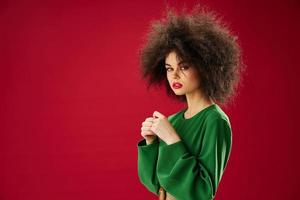 pretty woman in green dress afro hairstyle studio photo