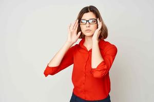 woman in red shirt wearing glasses emotions official office photo