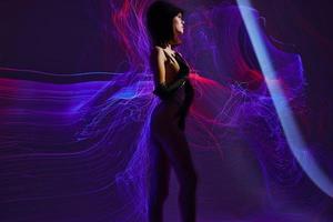 Positive young woman neon lines posing model glamor color background unaltered photo