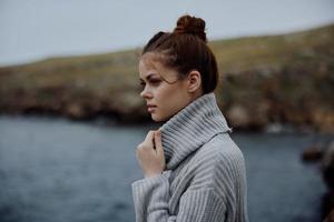 woman sweaters cloudy sea admiring nature unaltered photo