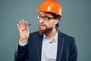 A man wearing an orange hard hat industry official job photo