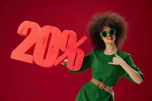 Beauty Fashion woman green dress afro hairstyle dark glasses twenty percent in hands color background unaltered photo