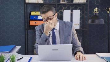 Intense and dominant office worker man is exhausted and sluggish. The businessman, who is bored with intense and tiring work, is exhausted and sluggish, and he becomes stressed. video