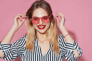 pretty blonde in striped shirt pink glasses glamor isolated background photo