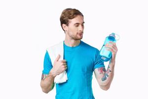 handsome man with a bottle of water in his hands sport fitness tattoo photo