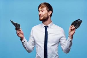 Cheerful man with wads of money in his hands success rich man photo