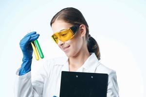 Woman in white coat laboratory assistant chemical solution research analyzes photo