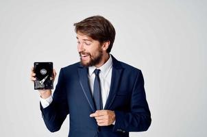 a man in a suit with a hard drive information recovery emotions photo