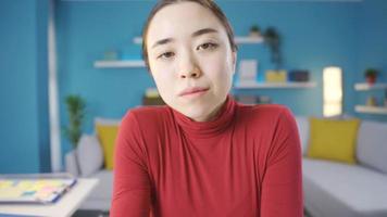 Young Asian woman looking at camera seriously. Young Asian woman standing motionless towards the camera. video