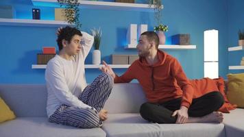 Younger brother and older brother who are grieving and unhappy at home at night. Sincere and understanding brothers chatting together at night at home. Sibling love. video