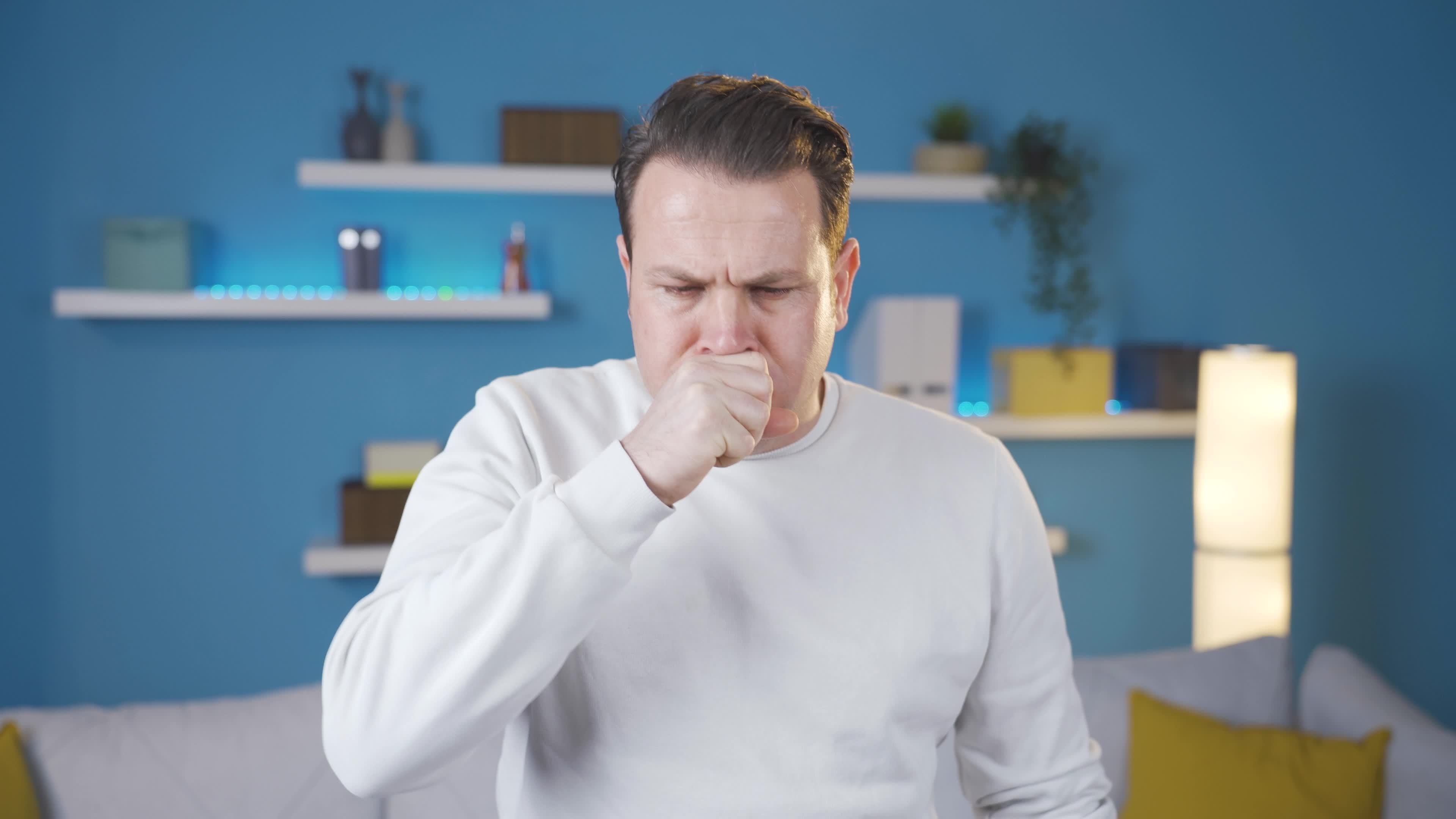 Sick man with sore throat coughing, feeling unwell. Sick man coughing