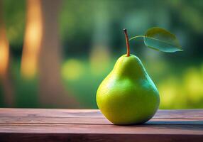 a green pear stands on a wooden table against the backdrop of a blurred garden. photo