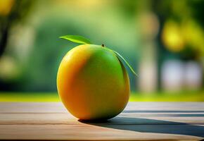 ripe mango on a wooden table against the backdrop of a green garden. photo