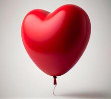 Red balloon in the shape of a heart on a white background. photo