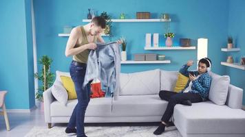 Little brother helping the unstyled older brother who asks for help in dressing up. Little brother helping his unstyled older brother who doesn't know how to wear clothes. video