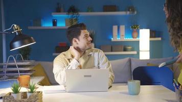 Freelance husband and wife conducting teamwork together. The couple, who are both co-workers and married, work together in the home office. Team work. video