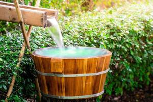 Wooden barrels for natural onsen, steam hot water from natural hot springs, soft focus. photo