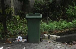 Green public park green trash garbage bin on outdoor place photo isolated on landscape template.