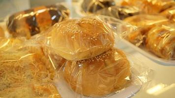 Bread in plastic bag on shelf in bakery shop, stock photo