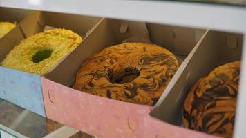 Sponge cake with chocolate pattern in an open package displayed in the shop window photo