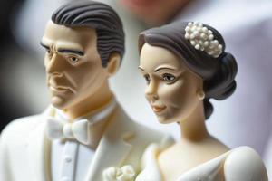 Bride and Groom on top of cake or dolls on top of cake. Nostalgia and memories of a good happy marriage photo