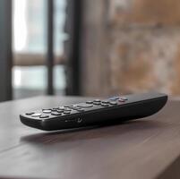 Close up of the remote on a wooden table - image photo