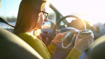 vrouw in bril gebruik makend van een smartphone in de auto video